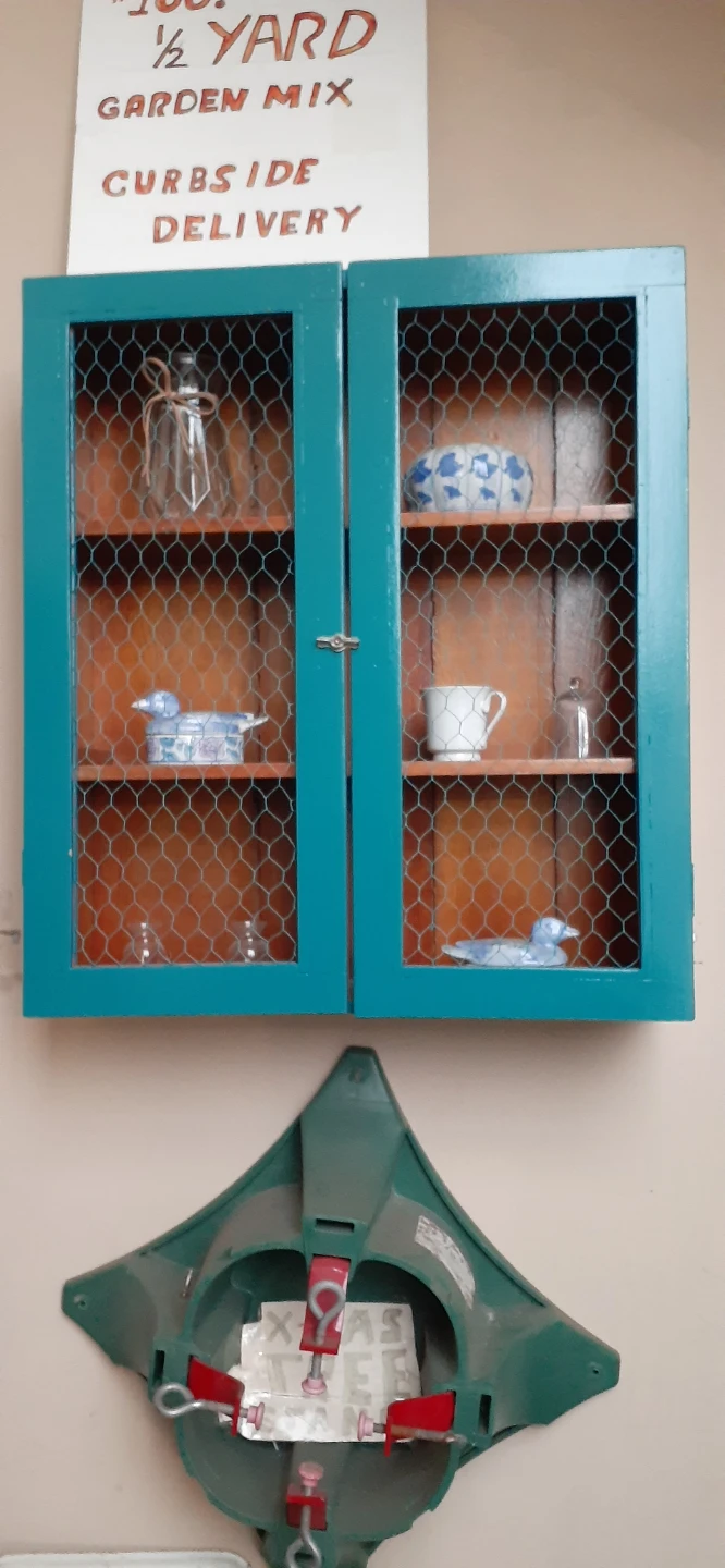 Teal Chicken Wire Cabinet with Glassware and Decor
