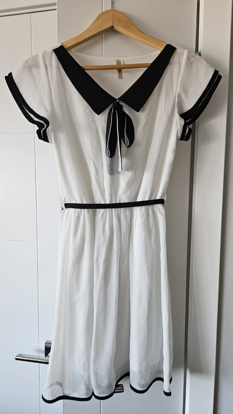 White dress with black trim and bow tie