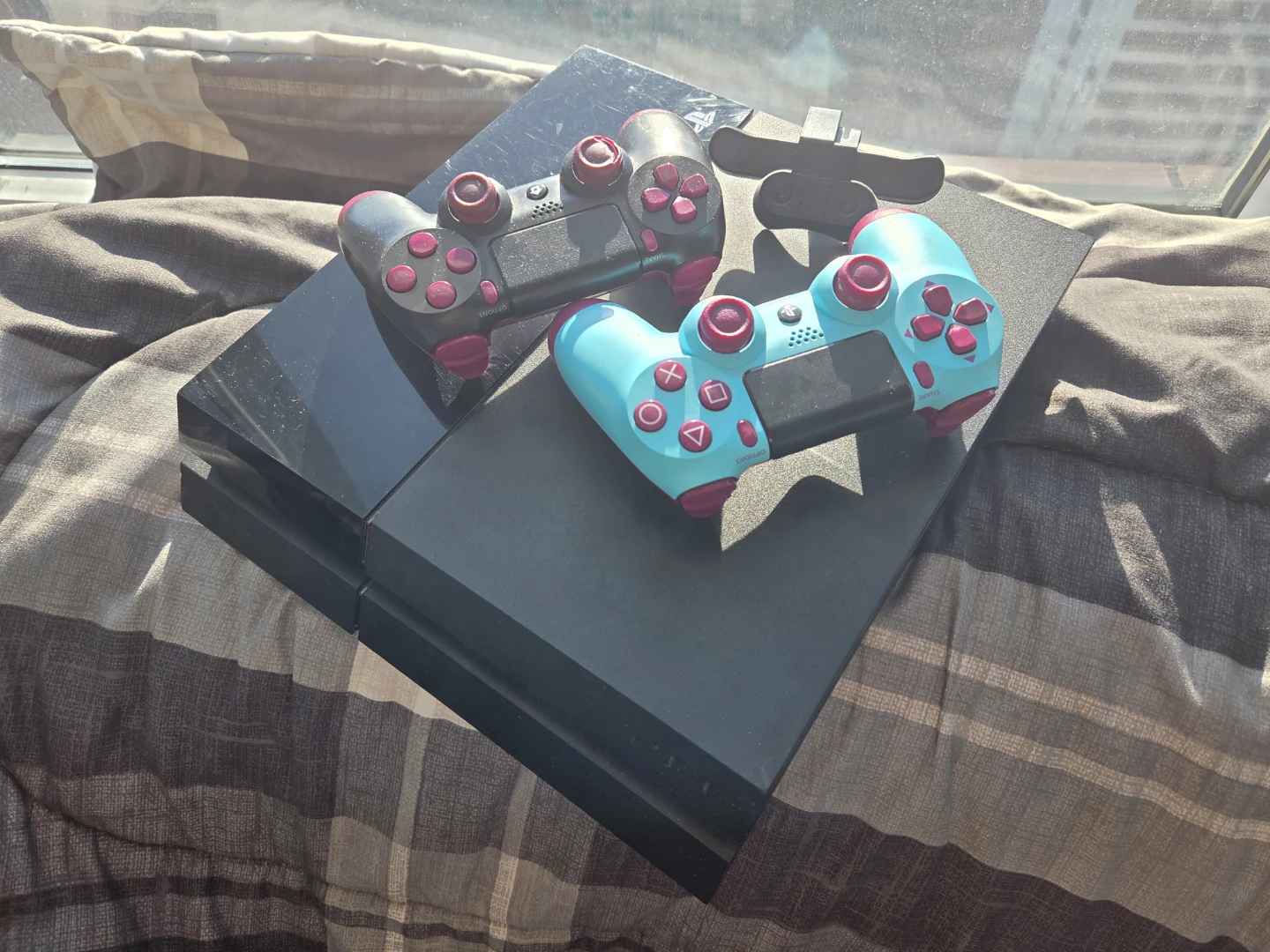 PlayStation 4 Console with Two Controllers and padels.