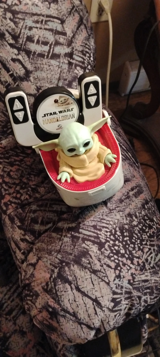 Grogu and hover pram called the mandalorian