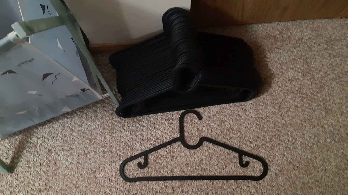 33 black plastic hangers