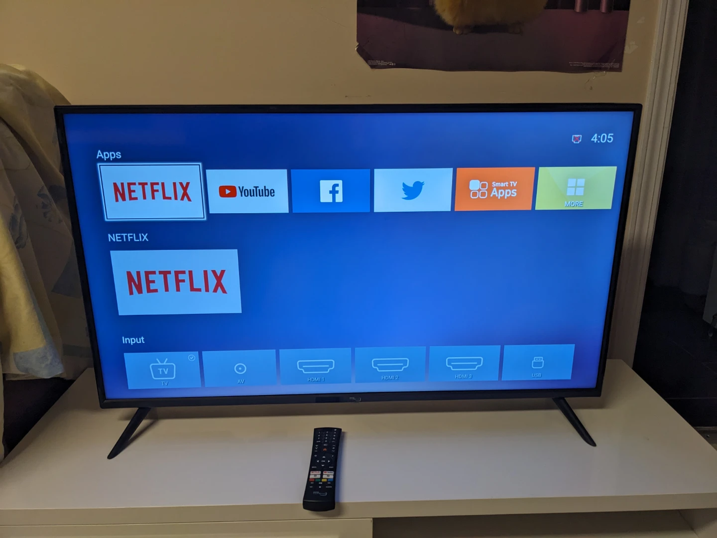 Black flat-screen smart TV with remote - photo 2