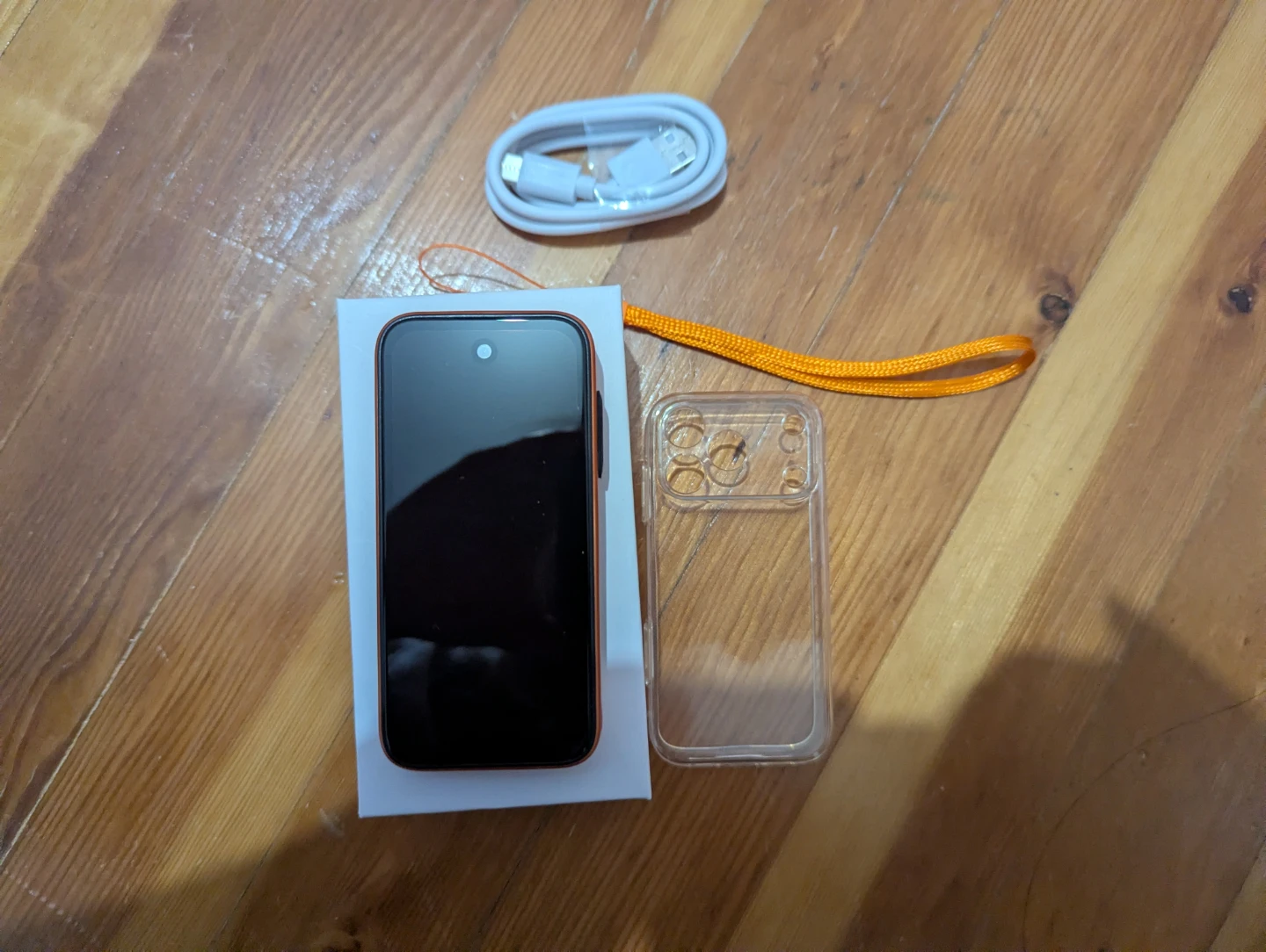 Orange Mini Smartphone with Case and Charger