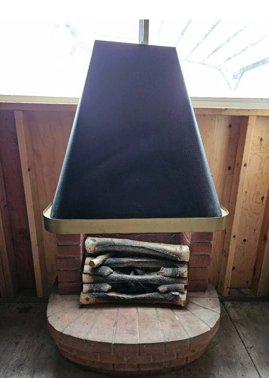 Vintage Brick Fireplace with Black Hood and Faux Logs