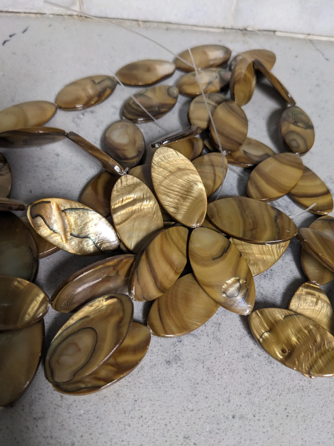 Flat oval mother of pearl shell beads 30x16mm gold brown