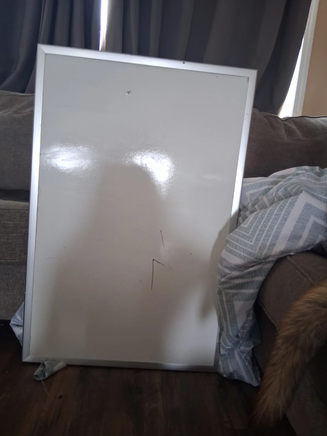 Whiteboard with silver frame with a little hole in it
