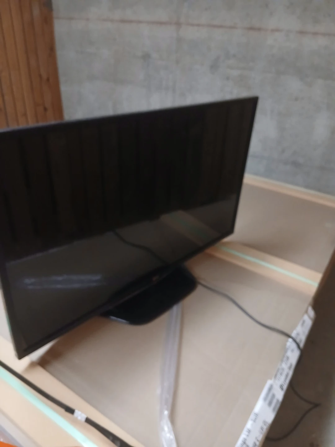 Black Flat Screen TV with Stand