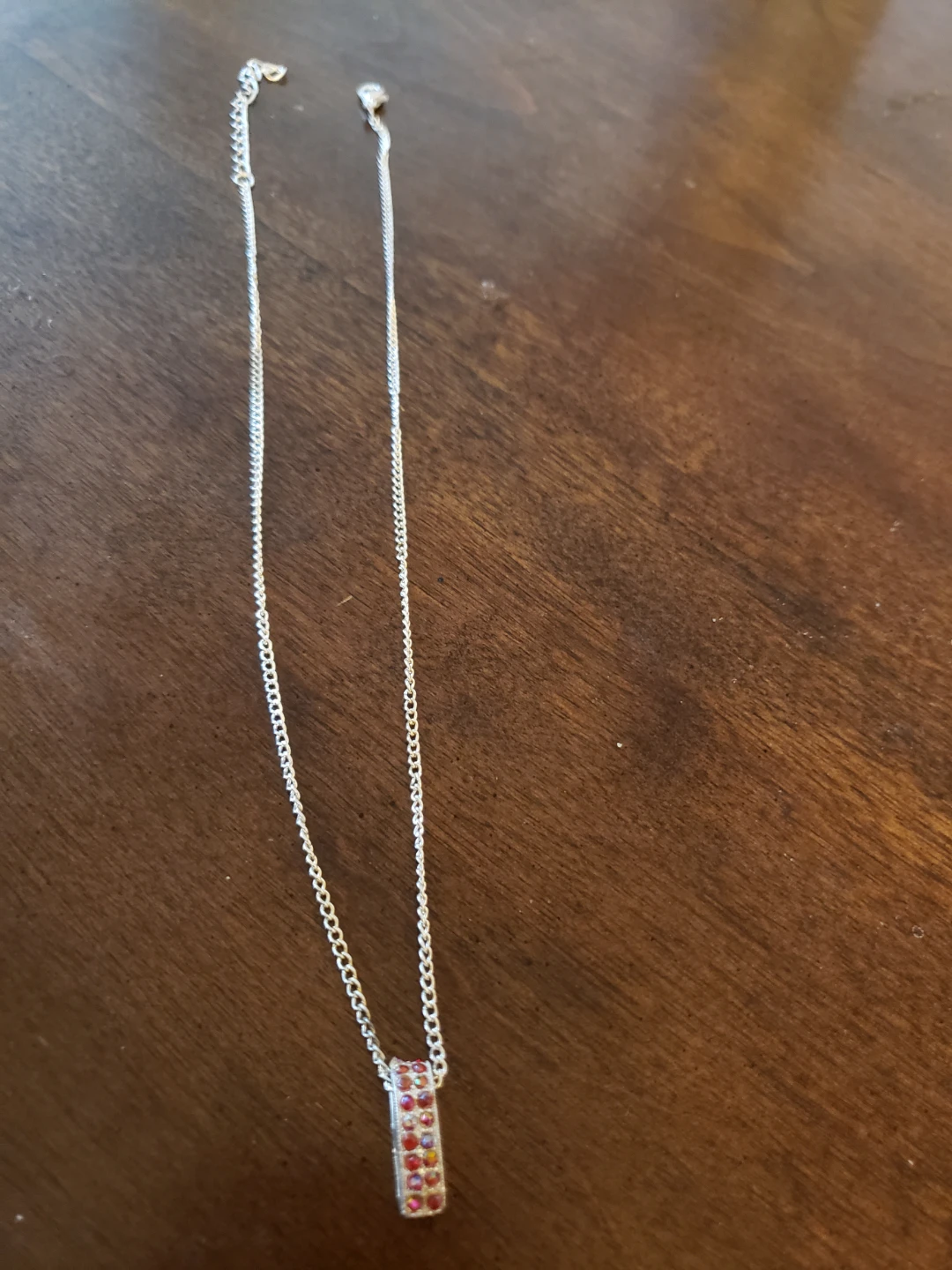 Silver tone necklace with rubi gems.