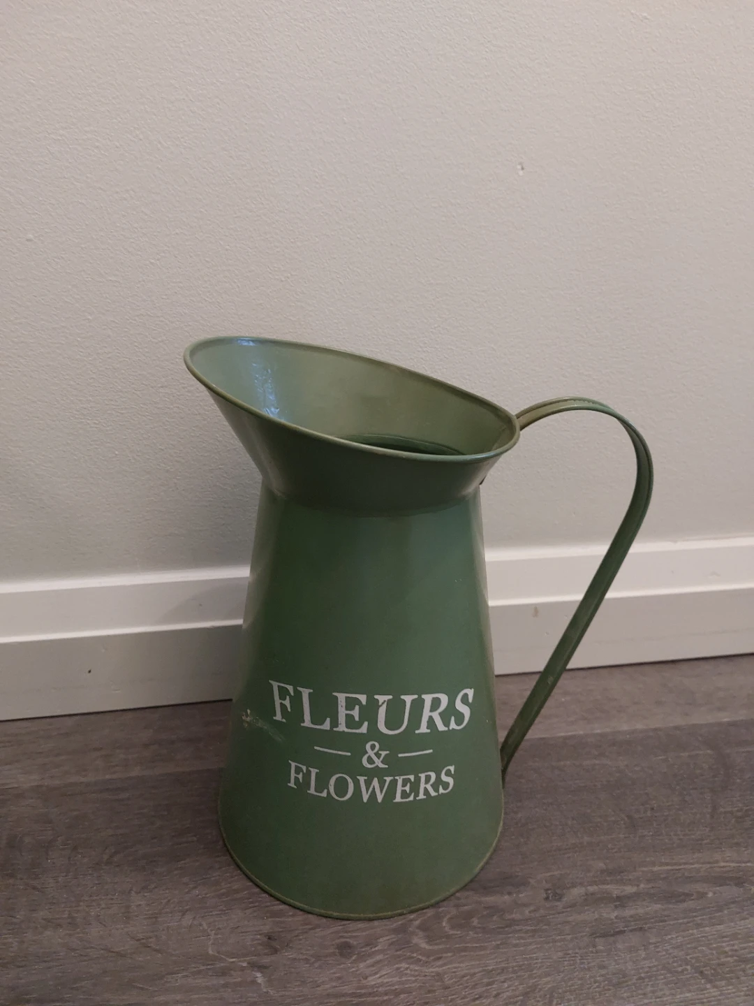 Green metal pitcher with "Fleurs & Flowers" inscription