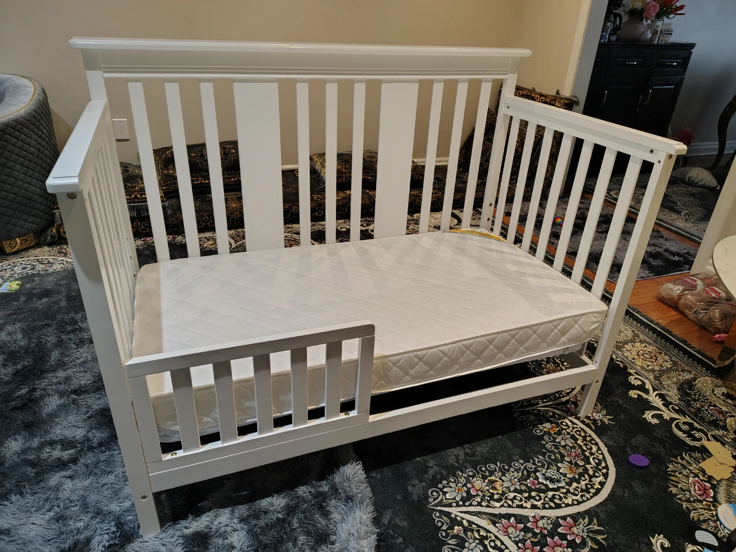 White convertible crib with mattress and toddler rail