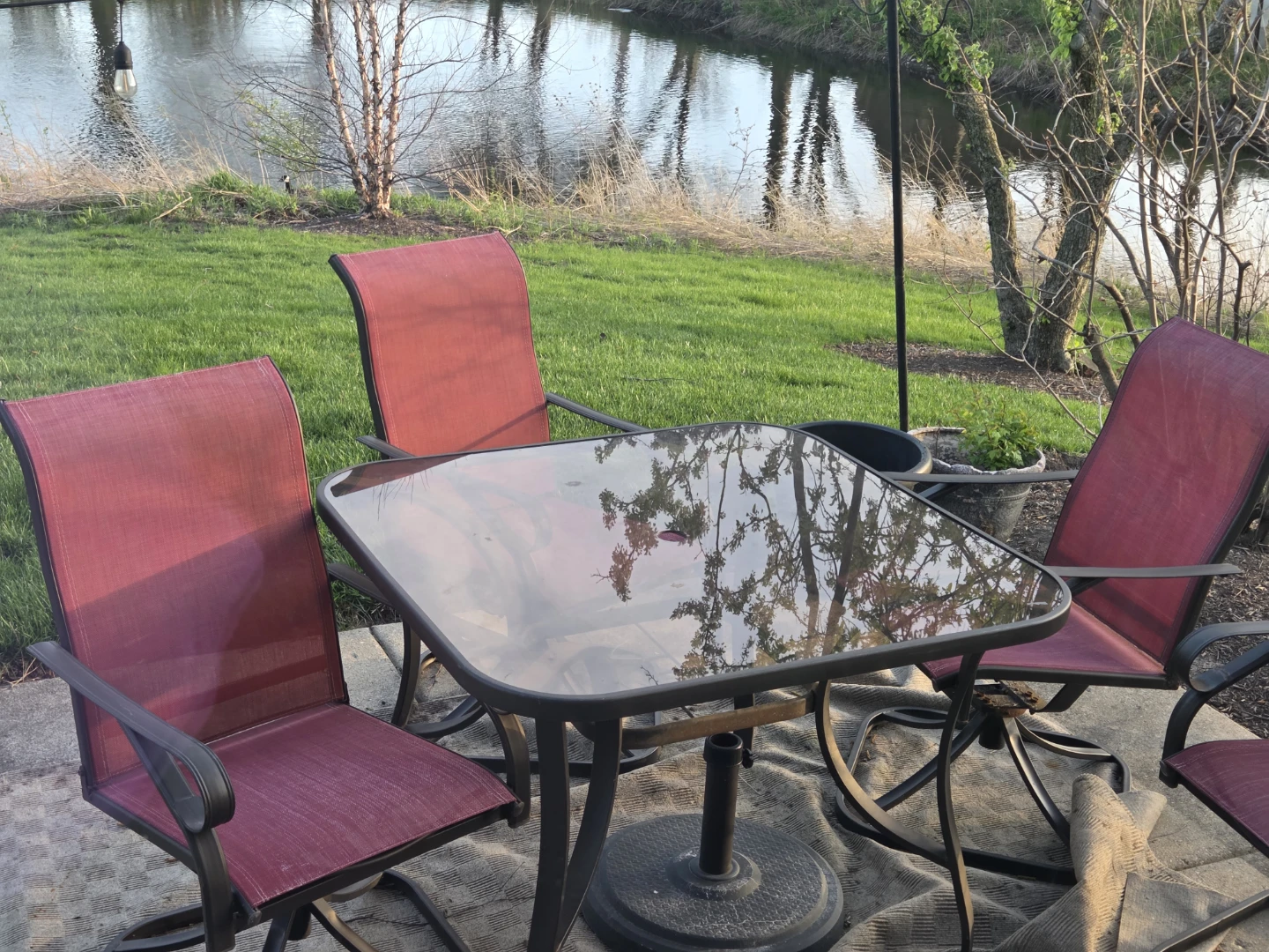 Sturdy Metal and Glass Top Patio Table with 3 Red Chairs