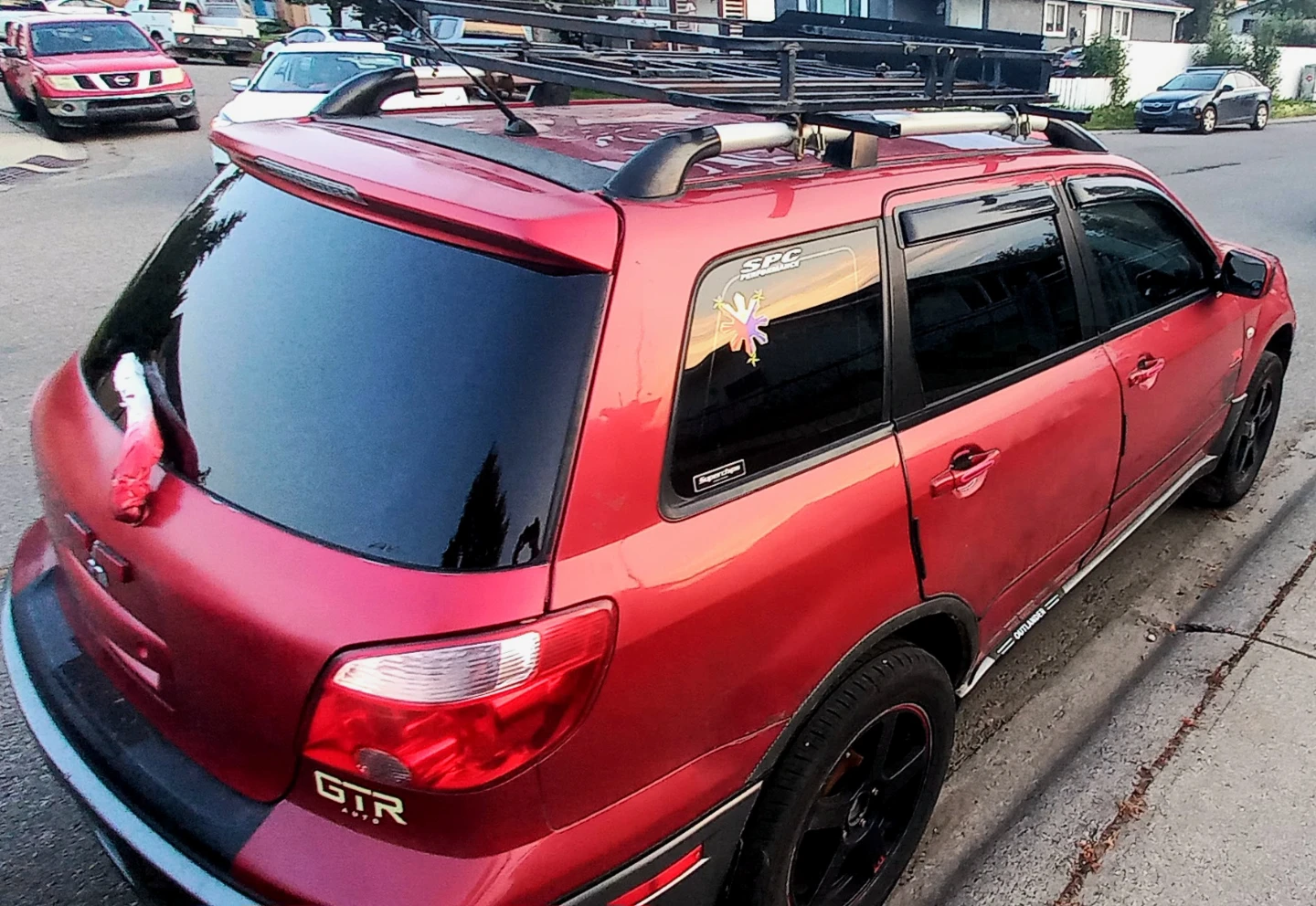 Red Mitsubishi Outlander SUV with Roof Rack