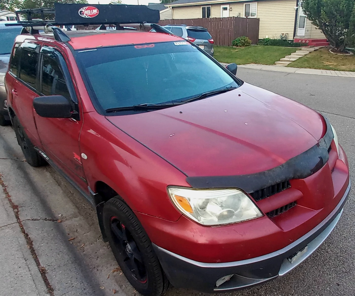 Red Mitsubishi Outlander SUV with Roof Rack - photo 2