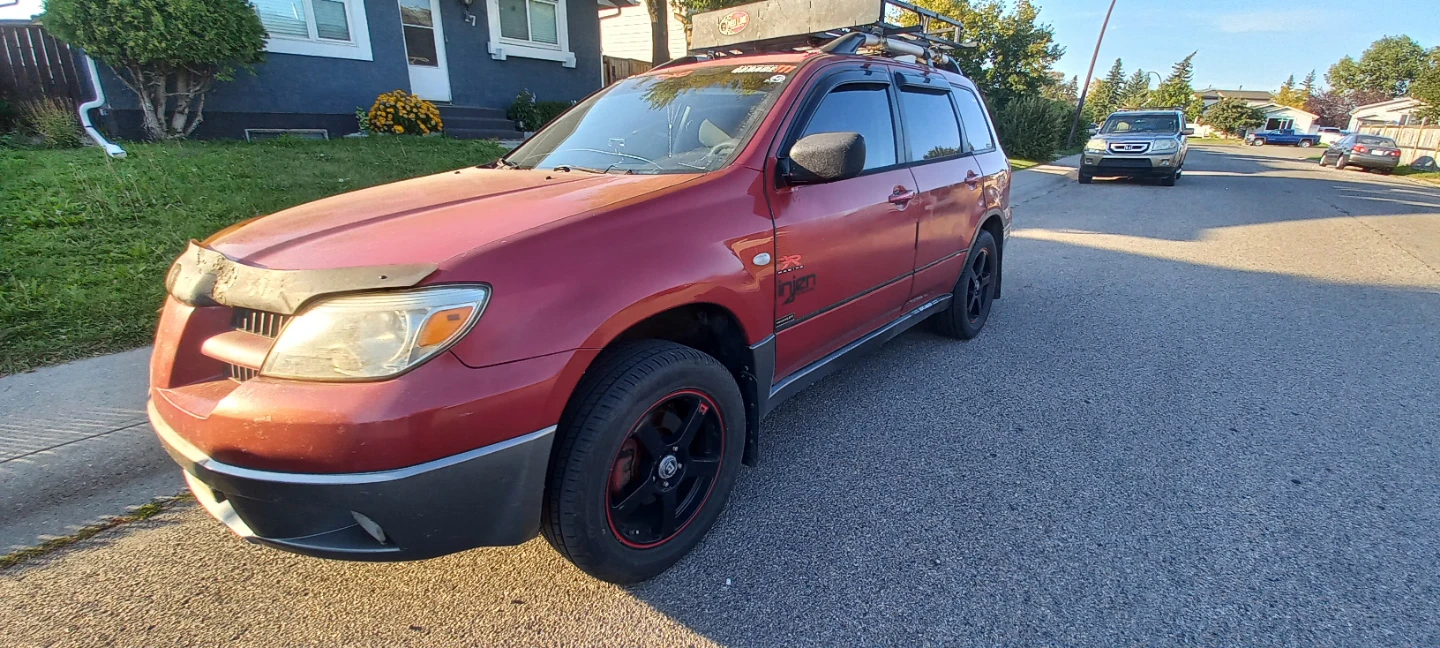 Red Mitsubishi Outlander SUV with Roof Rack - photo 5