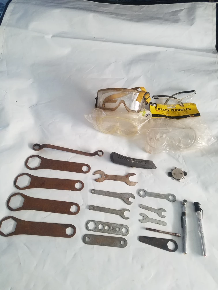 Assorted Wrenches, Safety Goggles, and Tire Pressure Gauges
