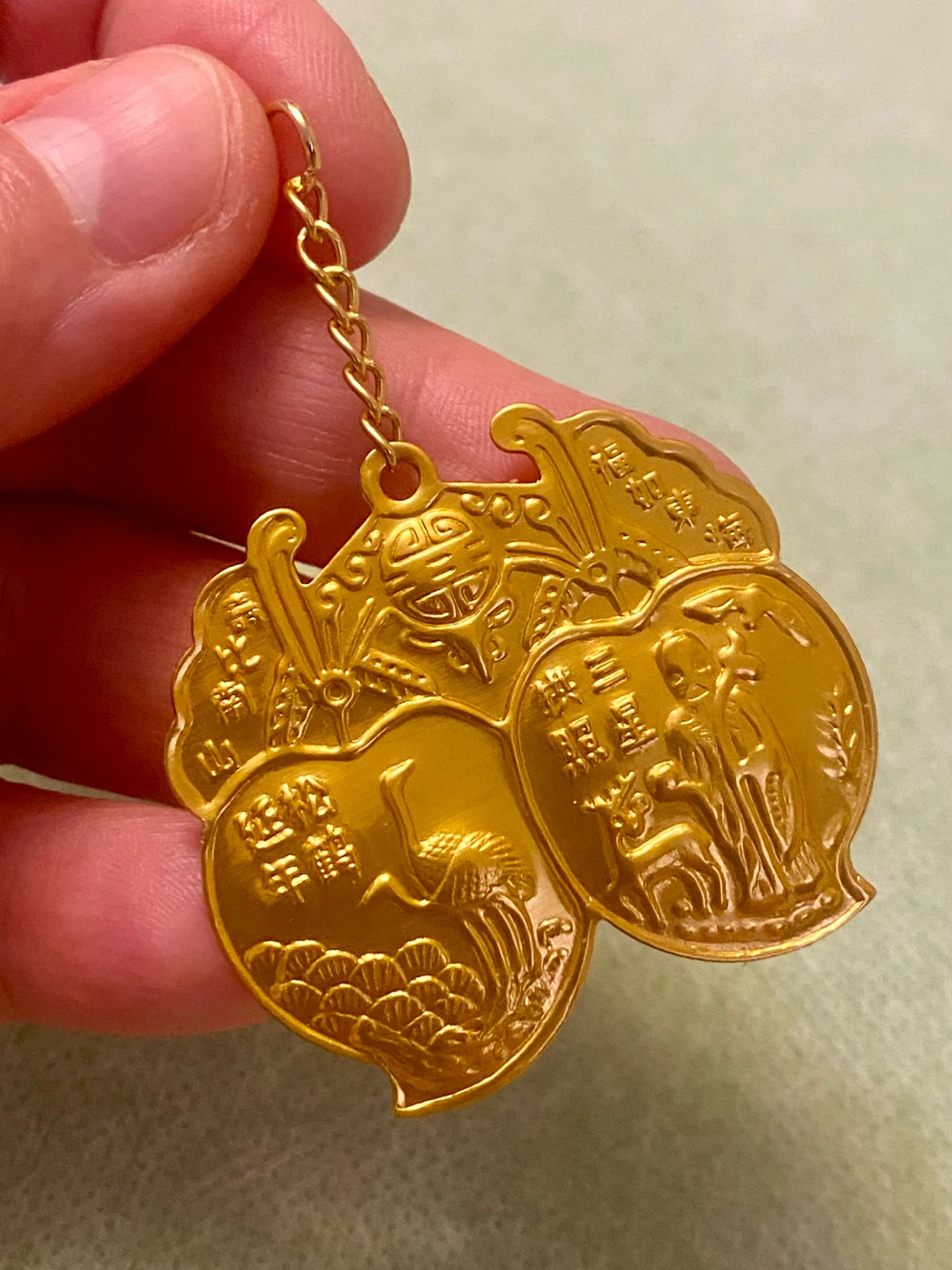 Gold Coloured Charm with Peach and Crane Design