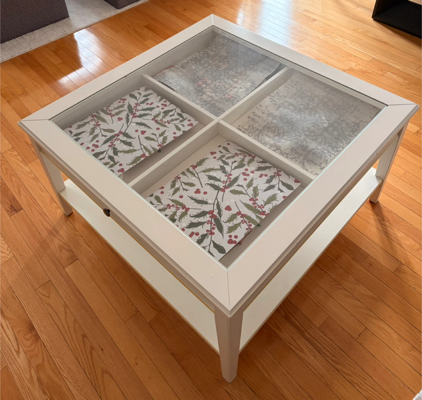 White IKEA coffee table with glass top and storage drawers