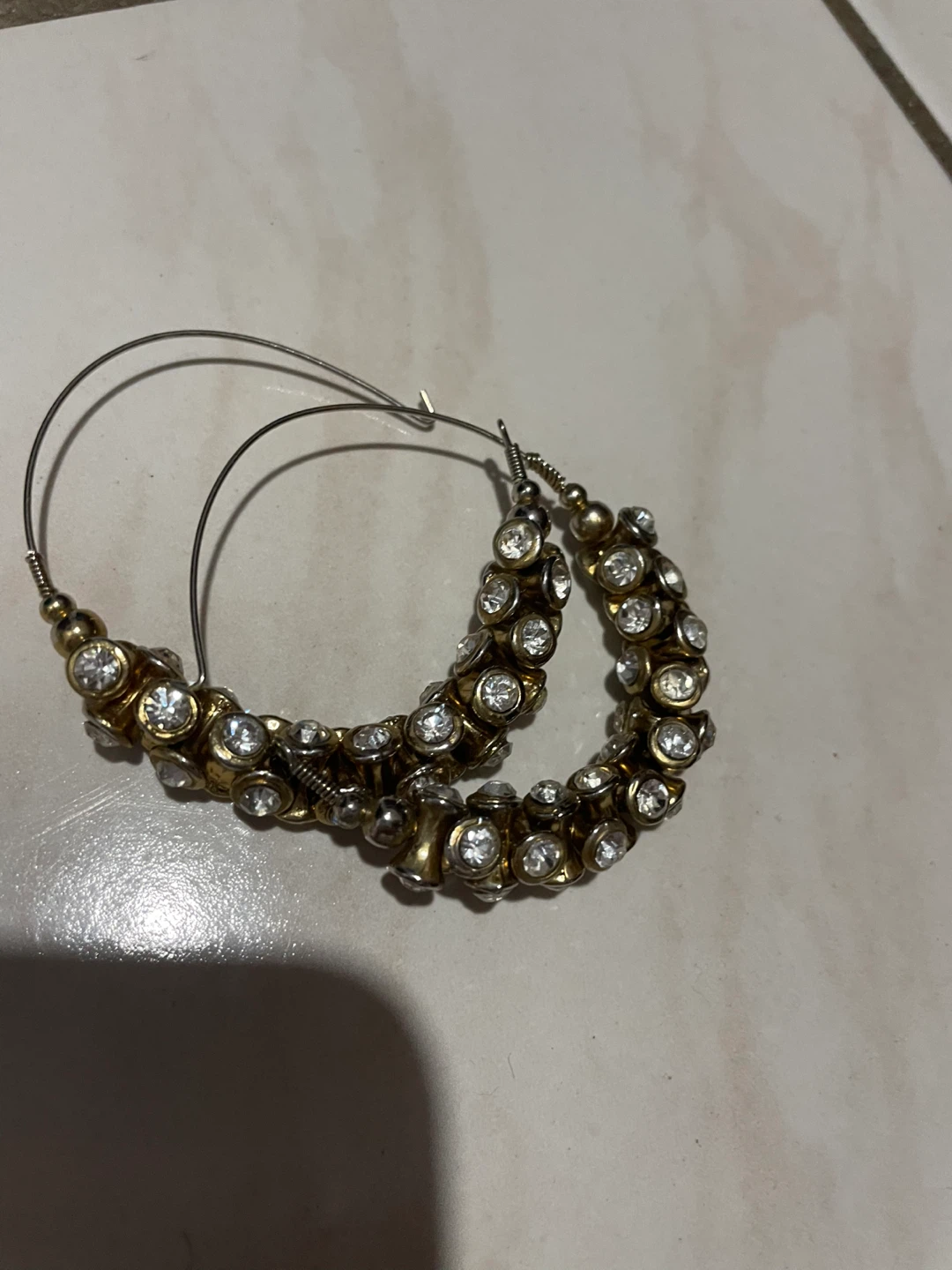 Gold tone hoop earrings with rhinestones
