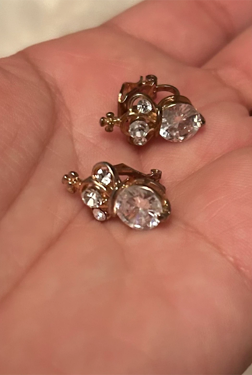 Gold-tone clip-on earrings with clear stones