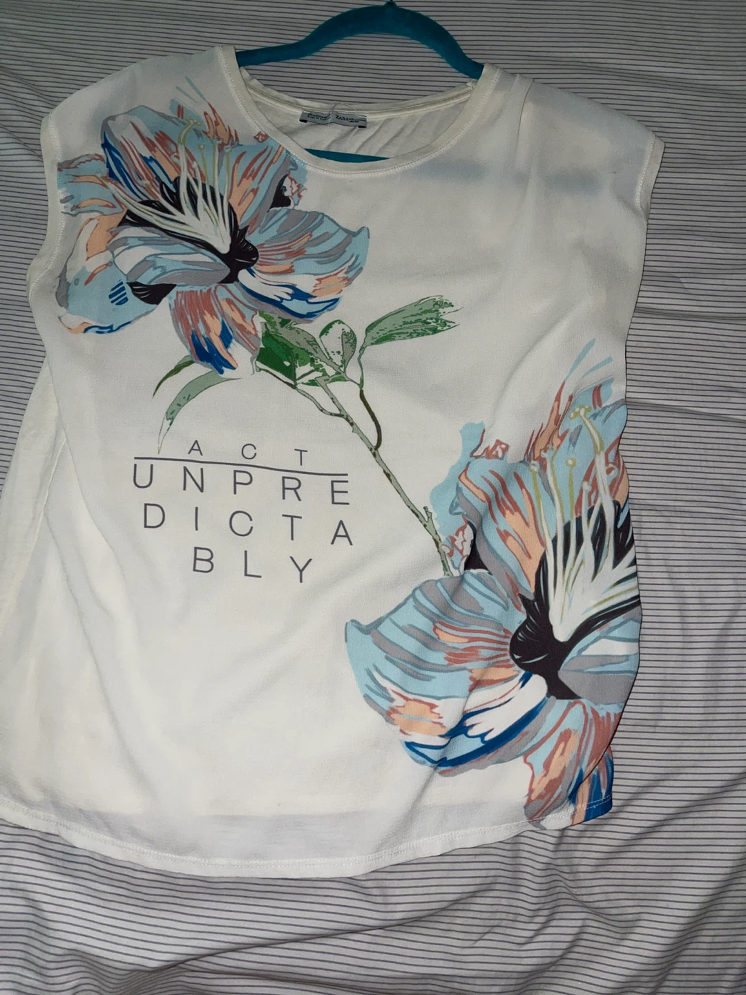 White Floral T-Shirt with "Act Unpredictably" Graphic