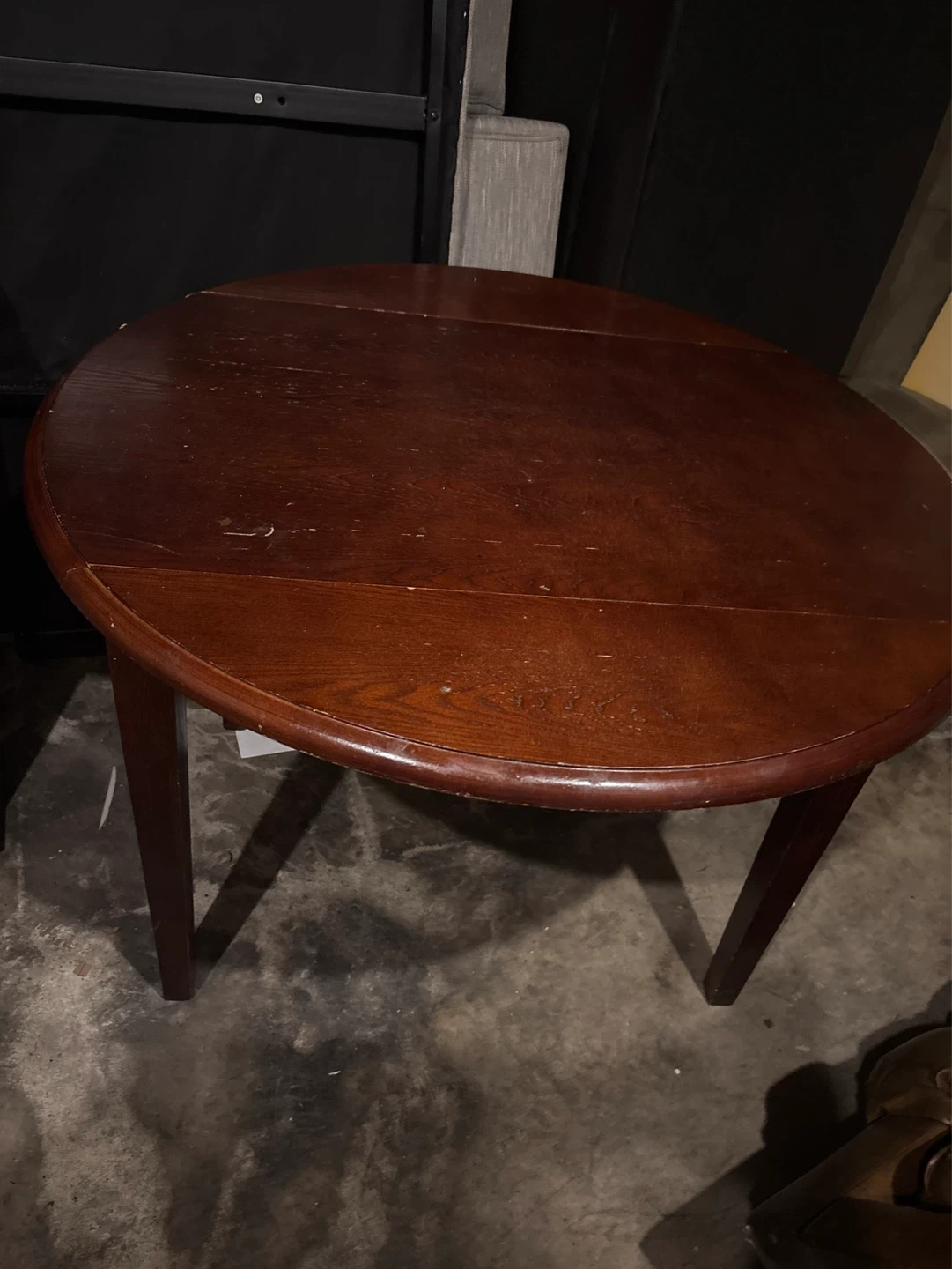 Round wooden table with sides that fold down