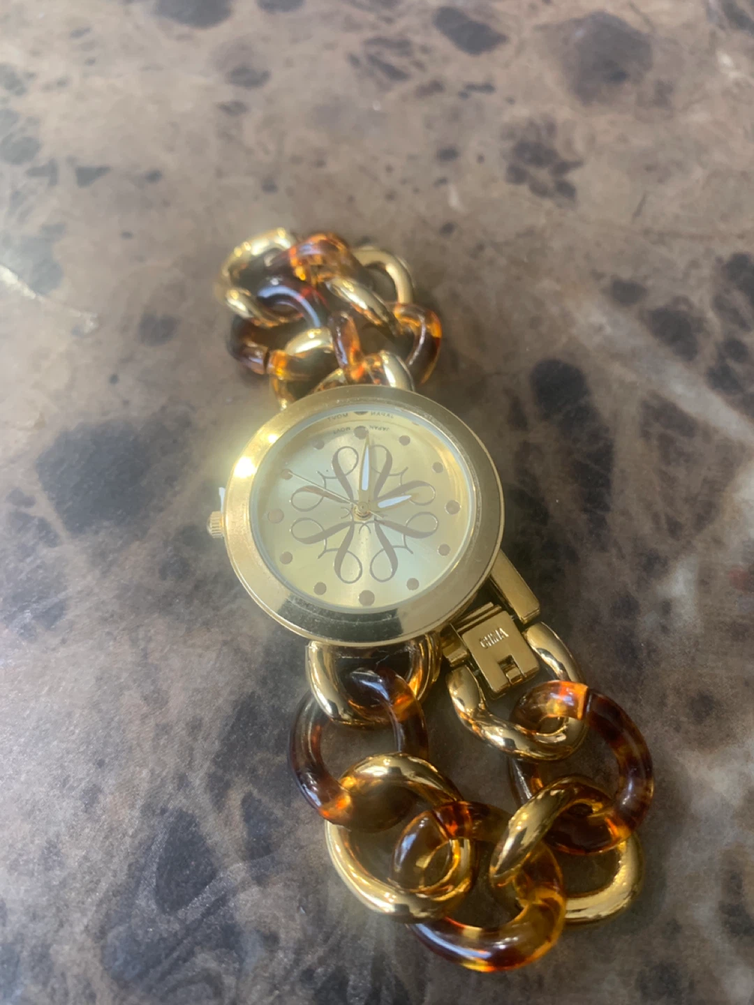 Gold-tone women's watch with tortoise chain
