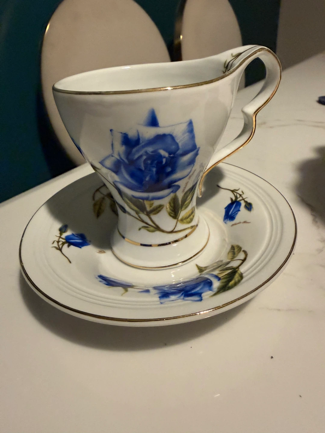 White Teacup and Saucer with Blue Roses and Gold Trim