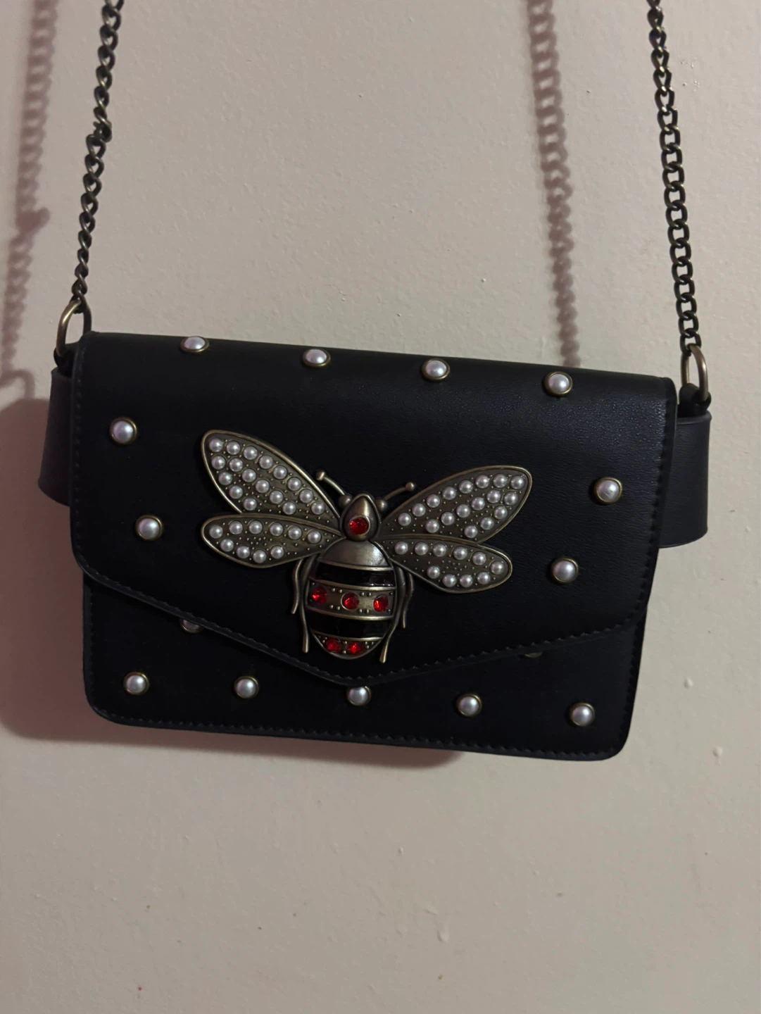 Black crossbody bag with bee embellishment