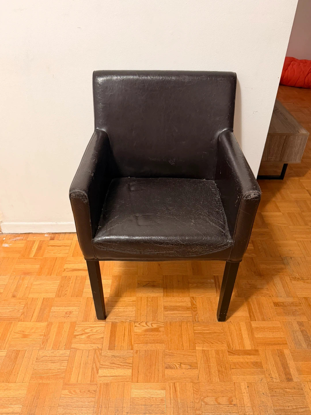Dark brown faux leather armchair