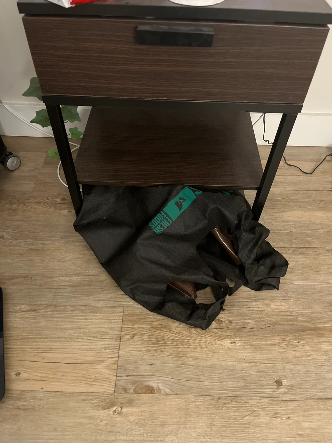 Brown wood-look nightstand with black metal frame