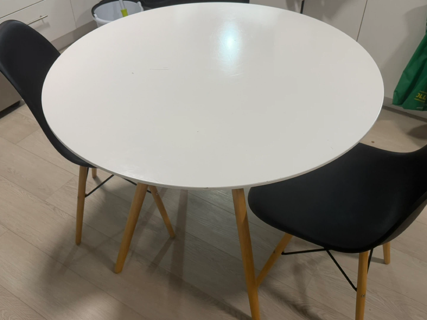 White Round Dining Table with 2 Black Chairs