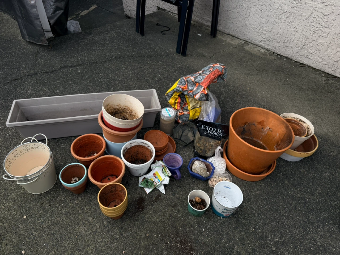 Shelving unit with assorted plant pots and garden supplies - photo 2