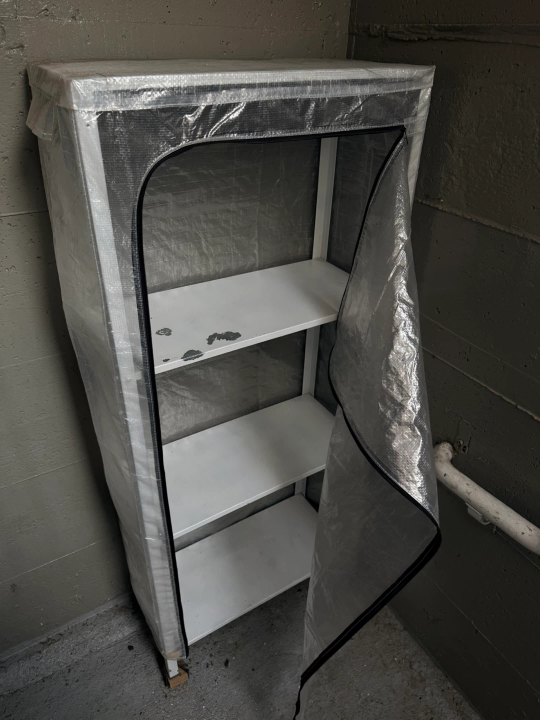Shelving unit with assorted plant pots and garden supplies - photo 3