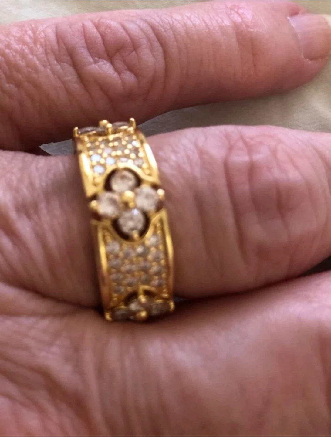 Gold-tone ring with clover design and crystals