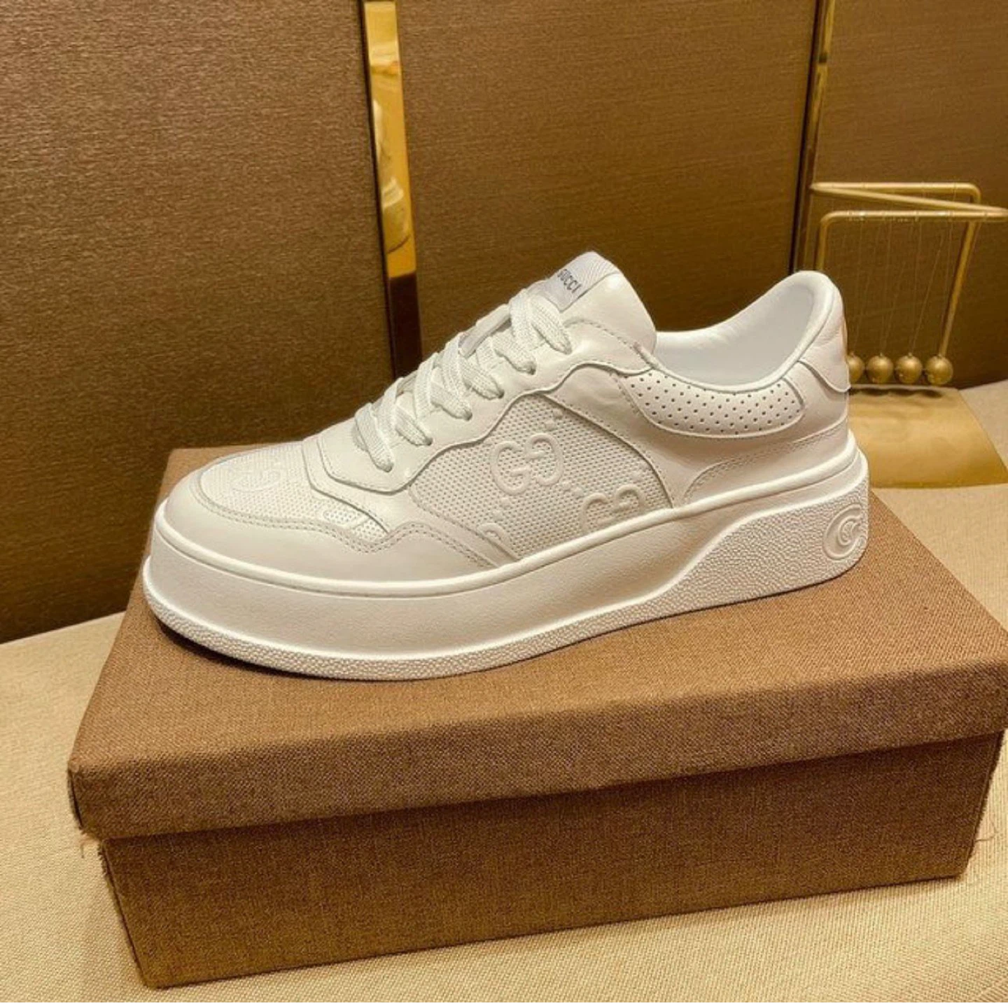 Gucci men’s White Leather GG Embossed Sneakers