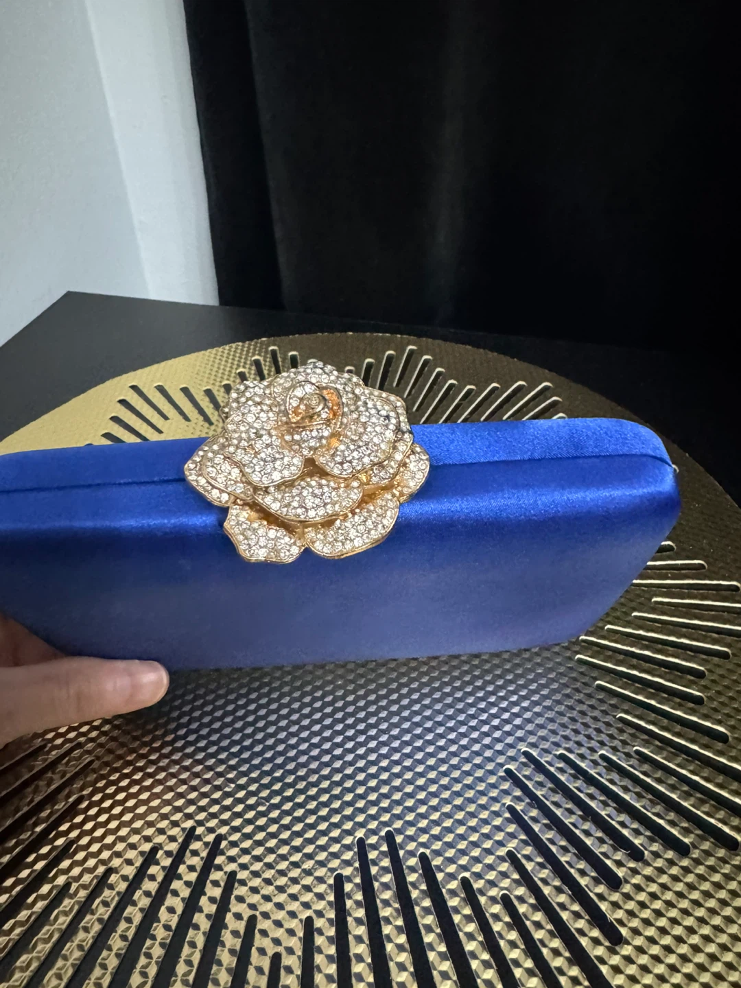 Blue satin clutch with rhinestone rose embellishment