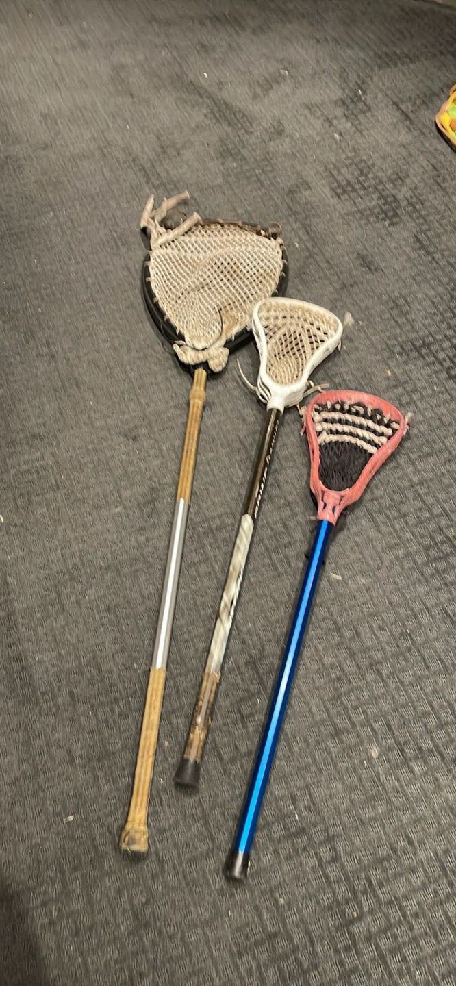 3 assorted lacrosse sticks 1 goalie and 2 junior player sticks