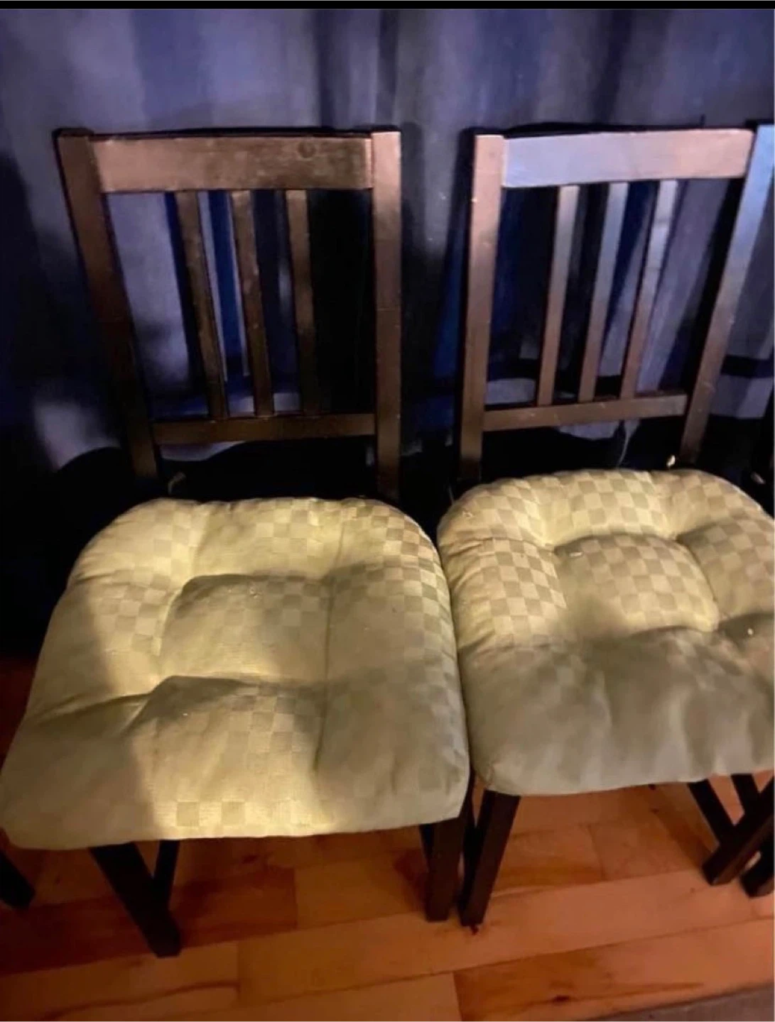 Two wooden dining chairs with upholstered seats