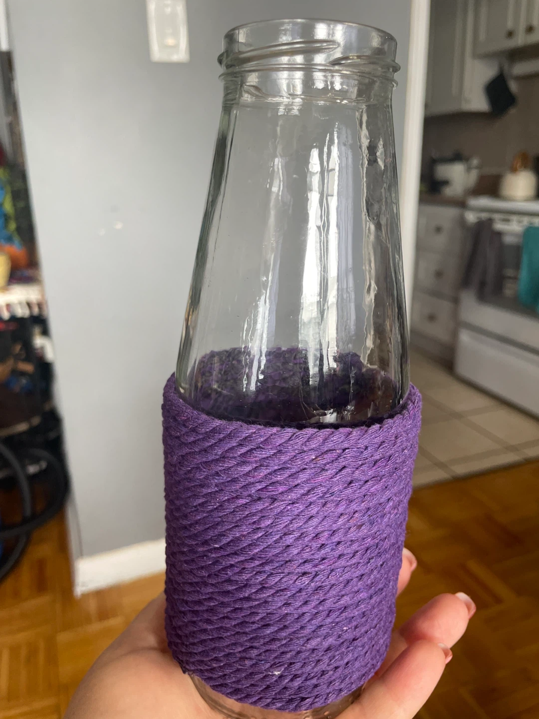 Glass bottle with purple twine wrap