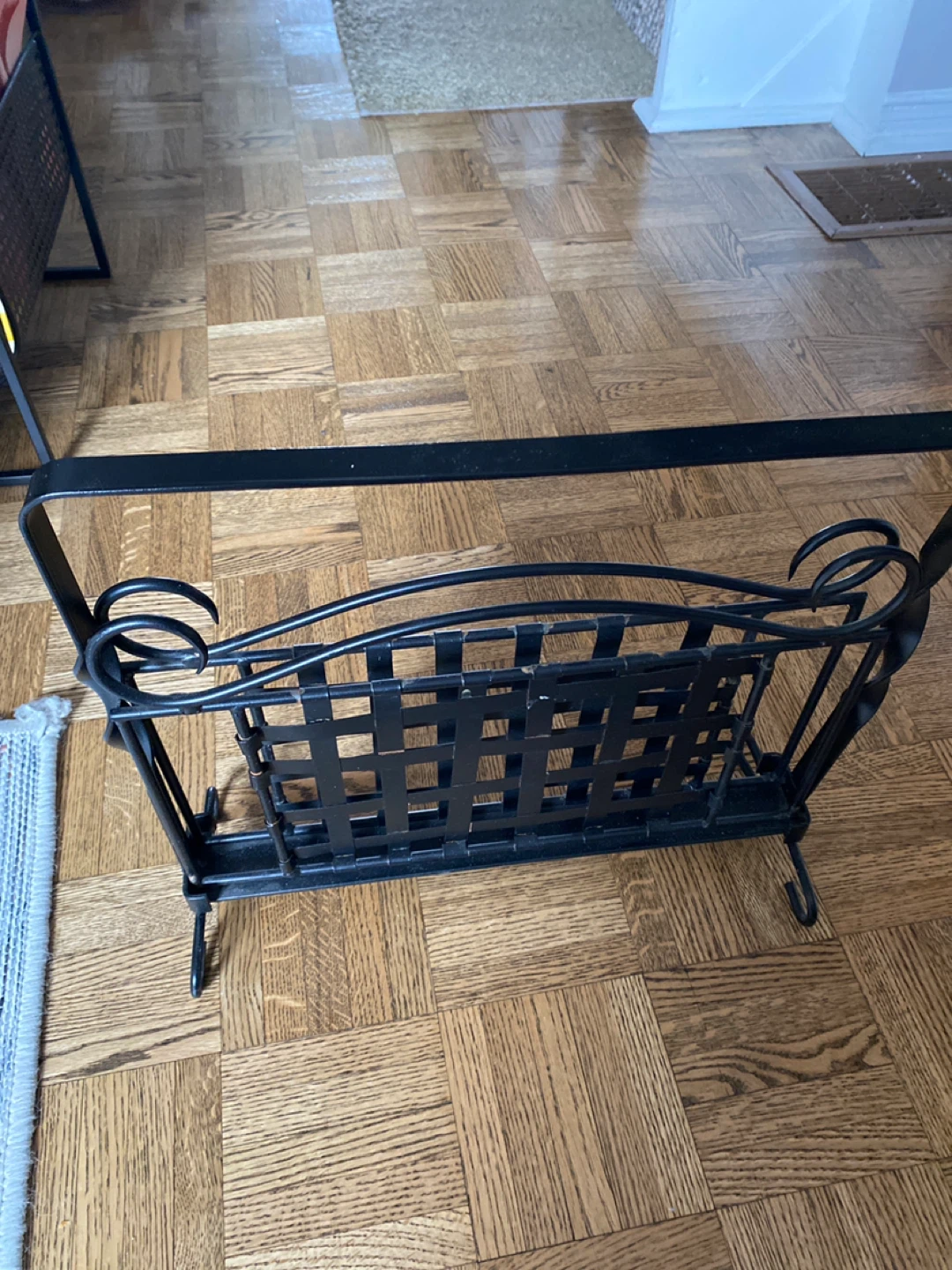 Black metal magazine rack with decorative scrollwork - photo 2