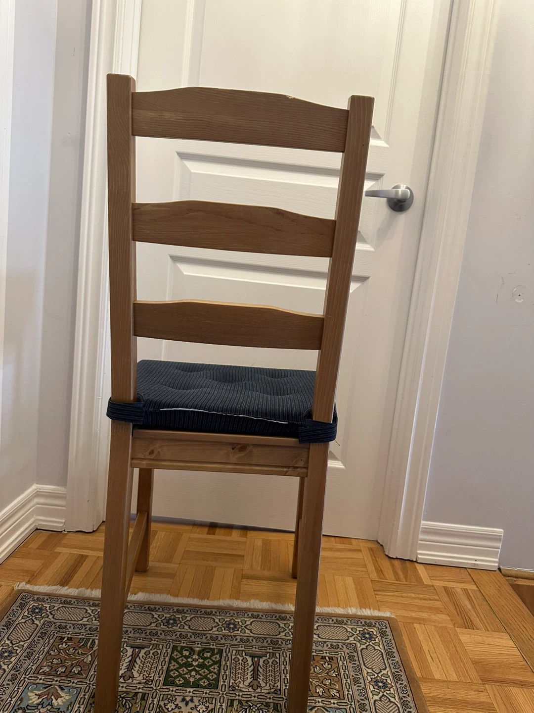 Wooden dining chair with dark blue cushion