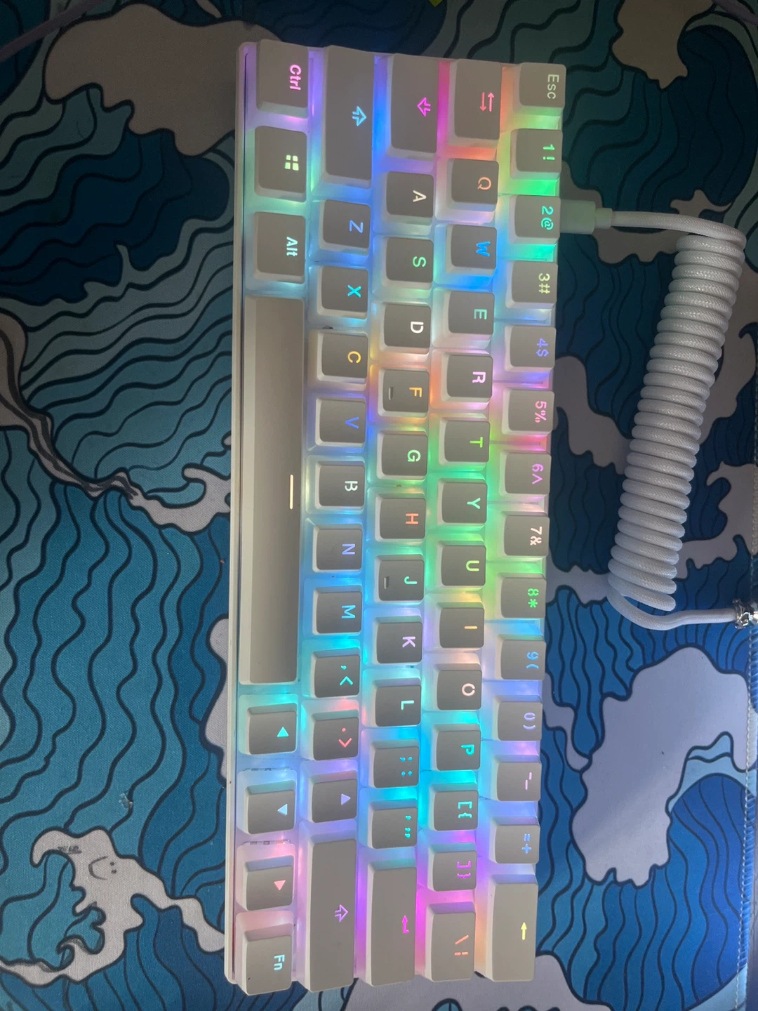Rk61 mechanical keyboard with pudding keycaps and a coiled cable