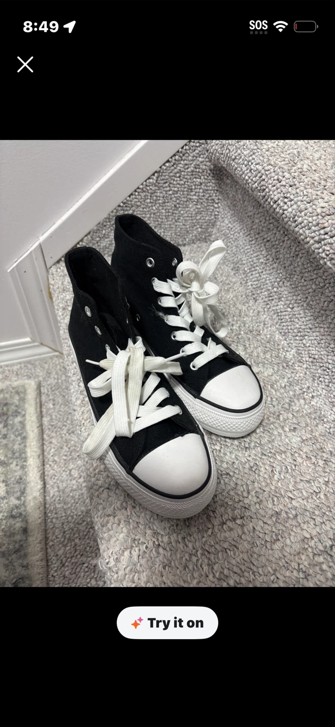 Black high-top canvas sneakers with white laces