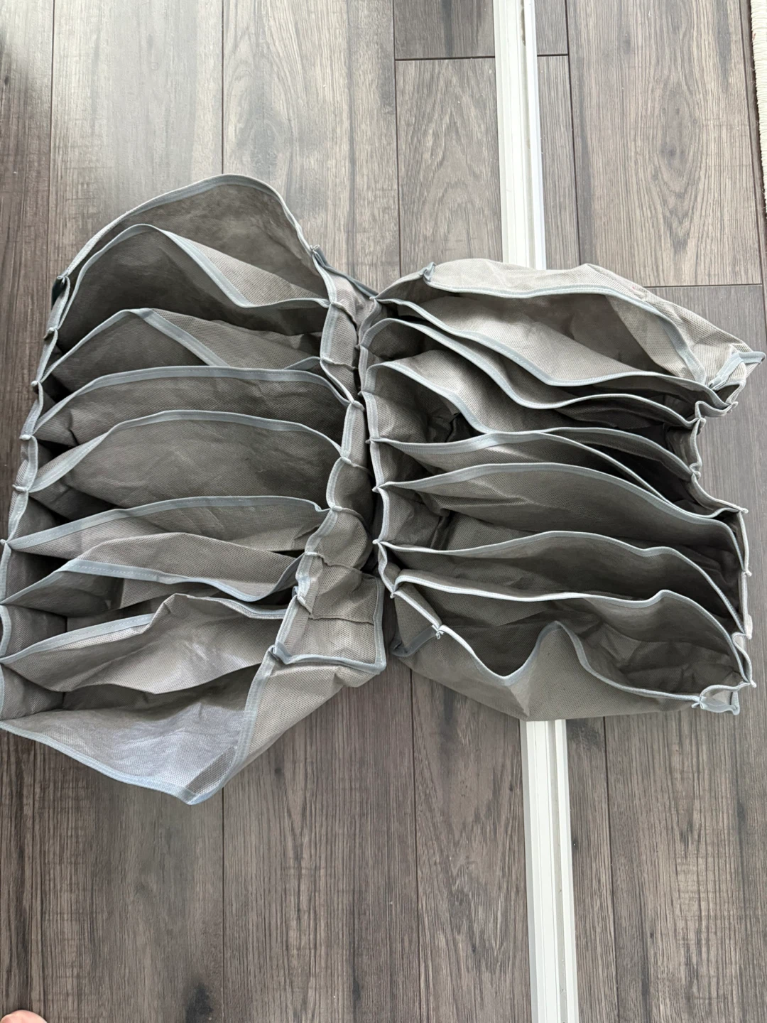2 grey mesh clothing organizers