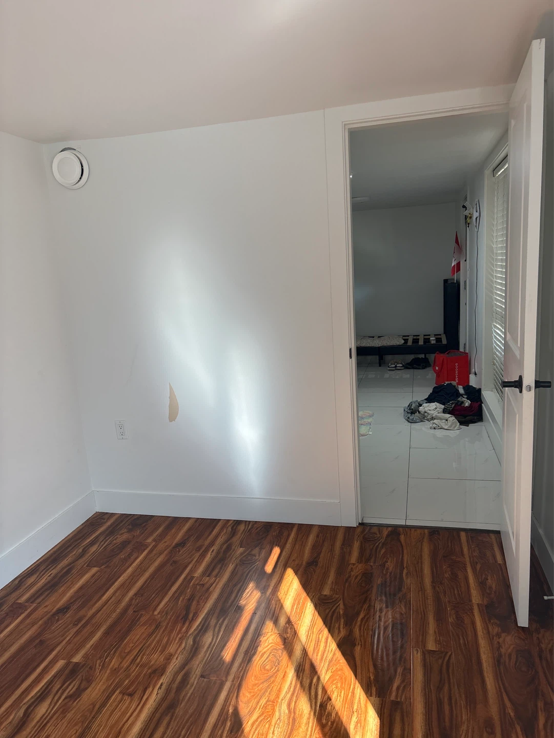Empty Room with Laminate Flooring and Window - photo 2