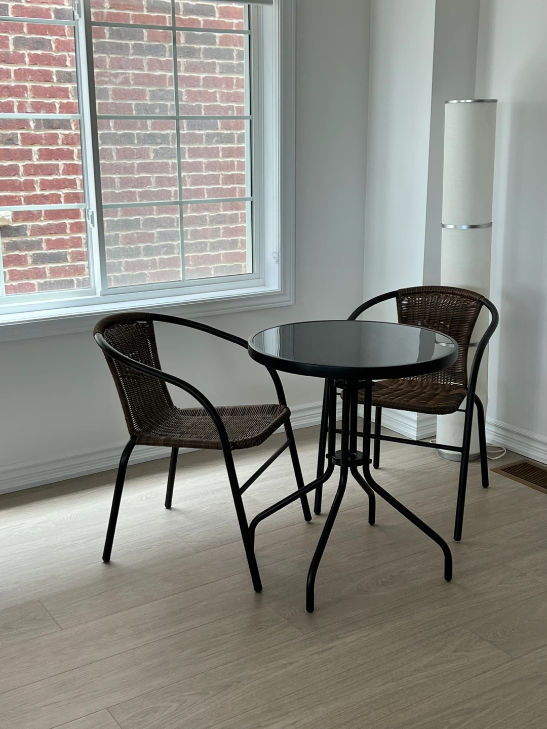 Black tempered glass table with two chairs and four chair pads