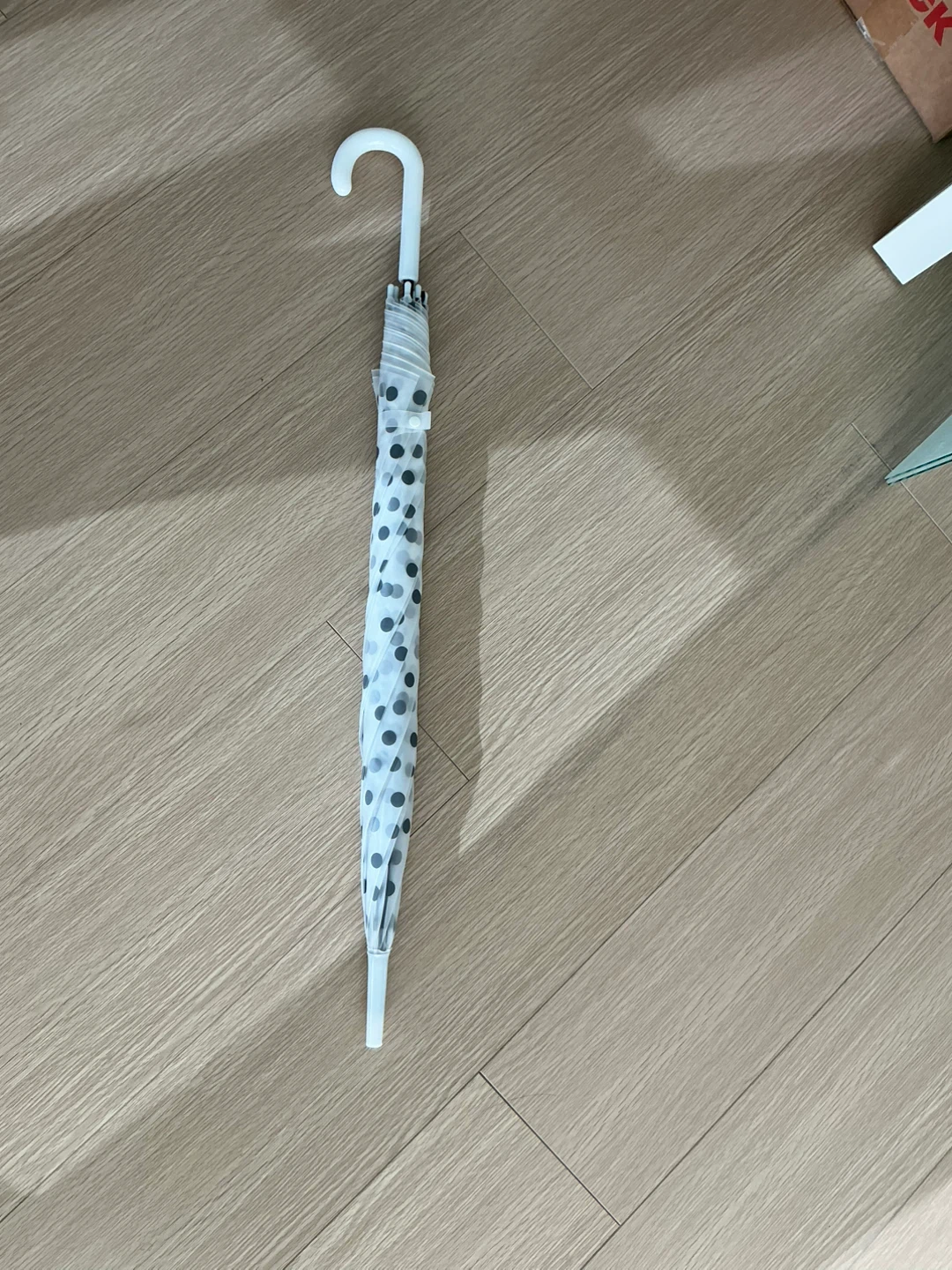 White umbrella with black polka dots