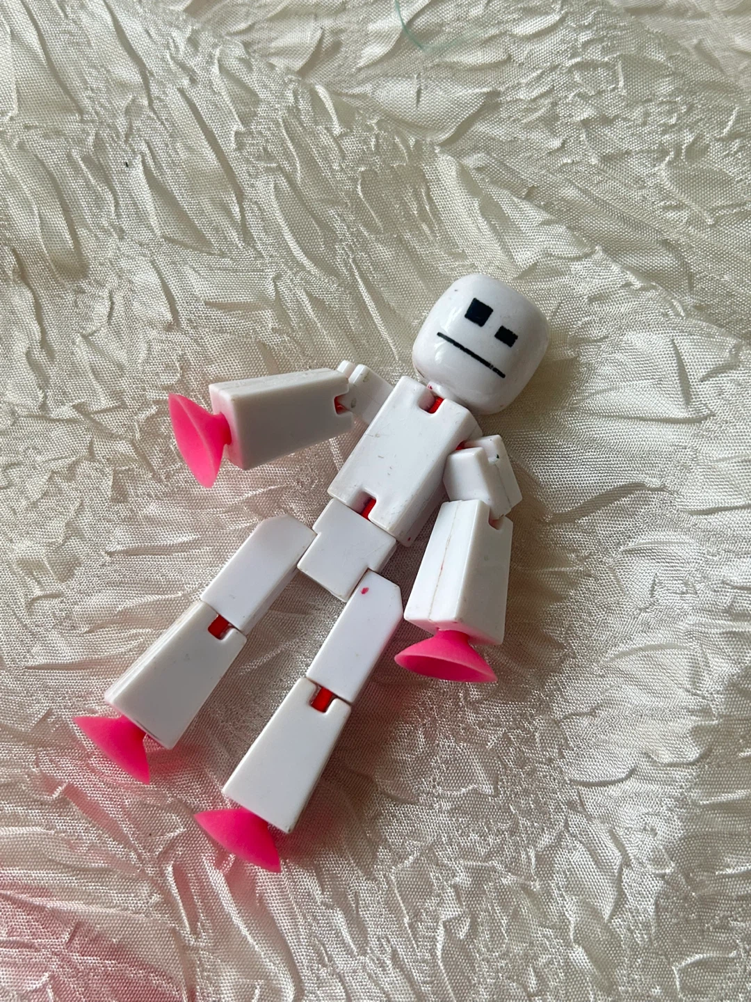 White Action Figure Toy with Pink Feet