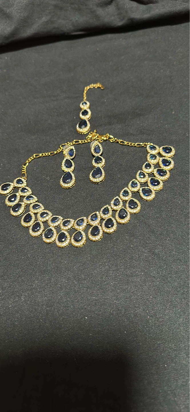Gold-tone blue stone necklace and earring set with tikka