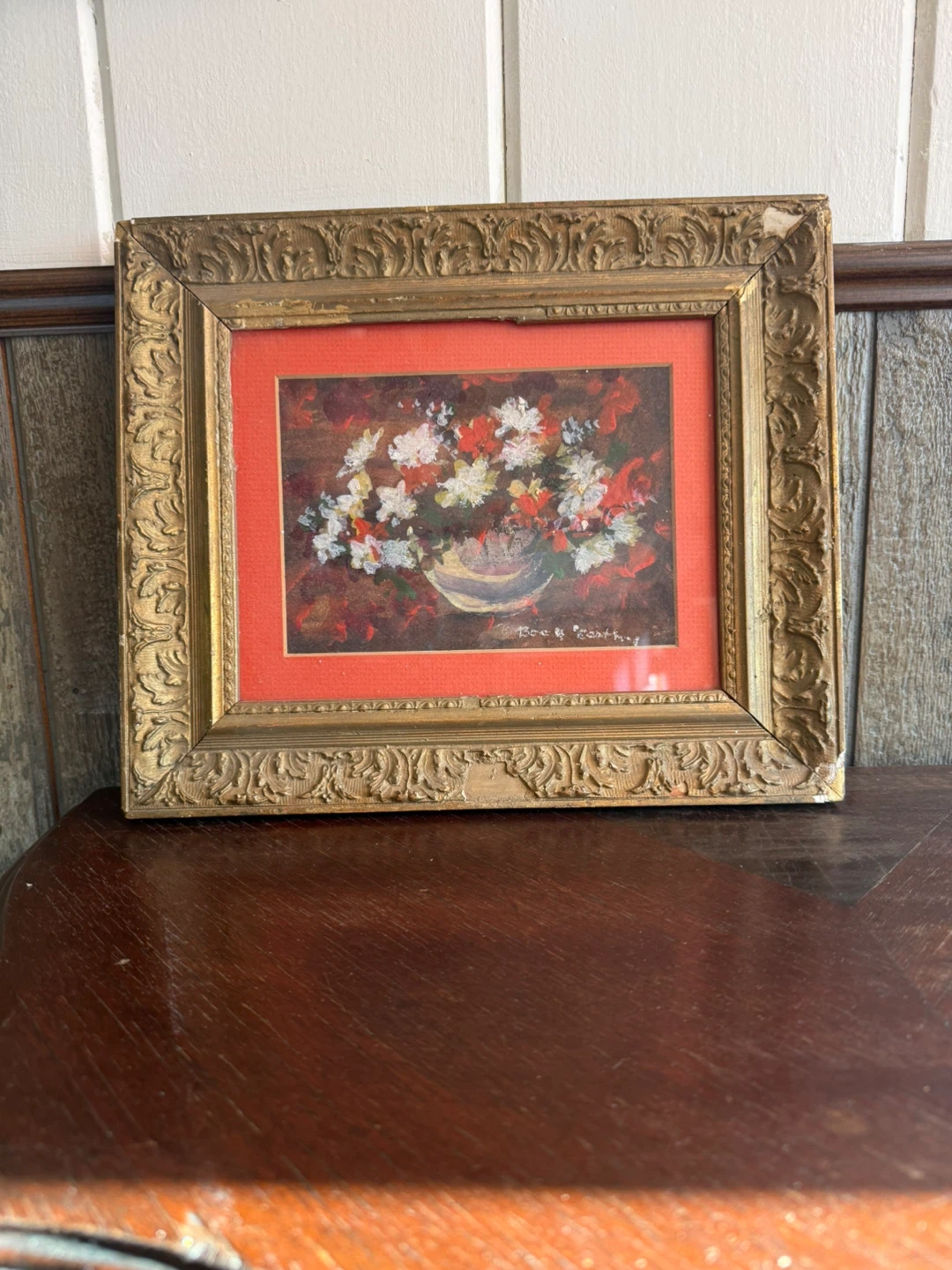Floral painting in ornate frame